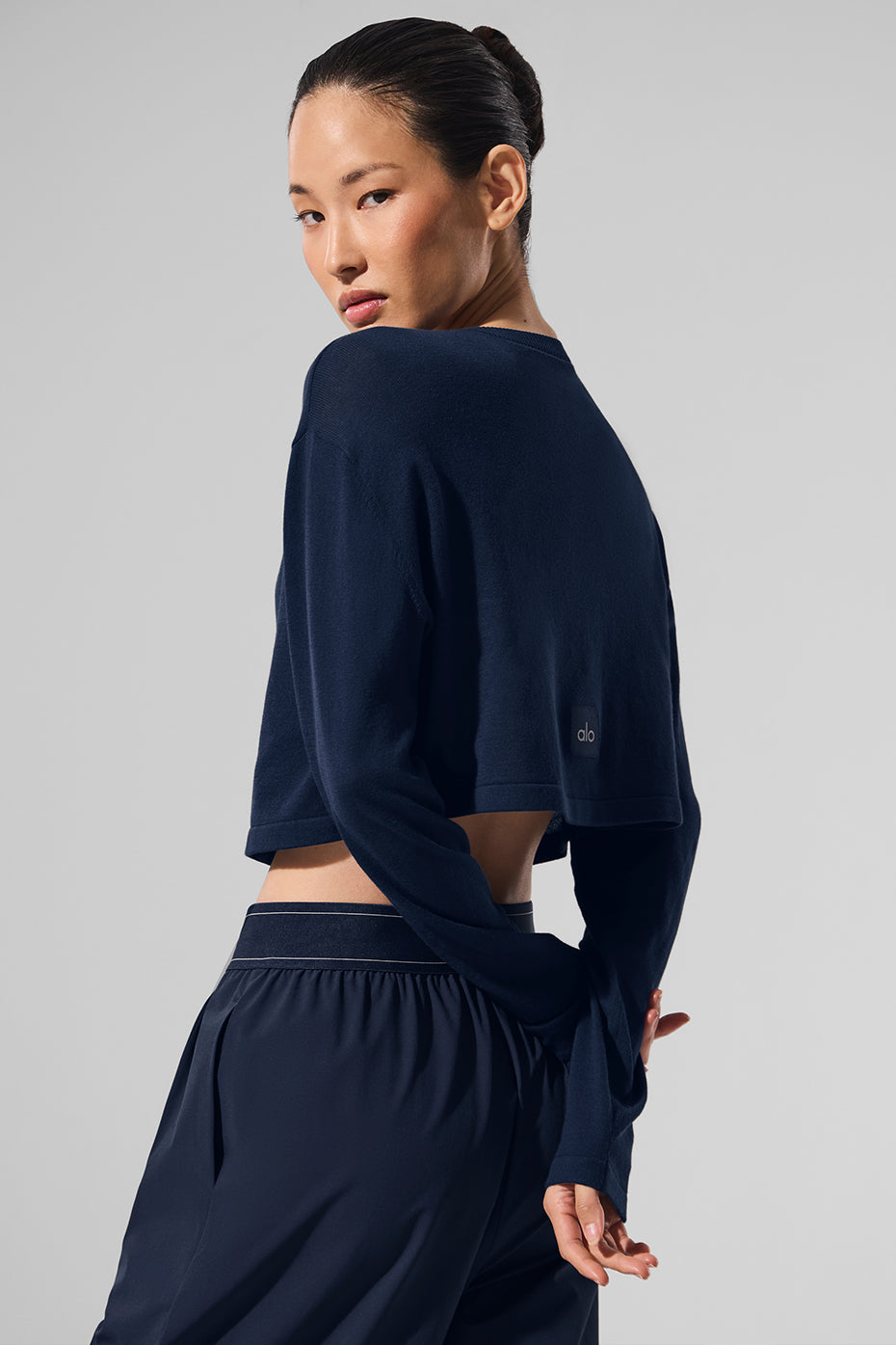 Front view of navy lightweight cardigan styled with a sweater dress.