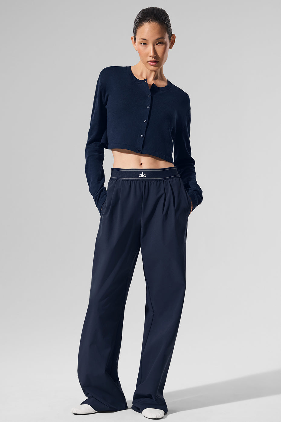 Navy cardigan draped over a casual outfit for a chic look.