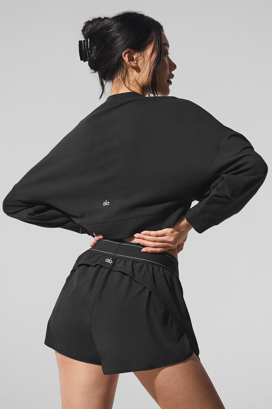 Back view highlighting the stylish design of the cropped sweatshirt.