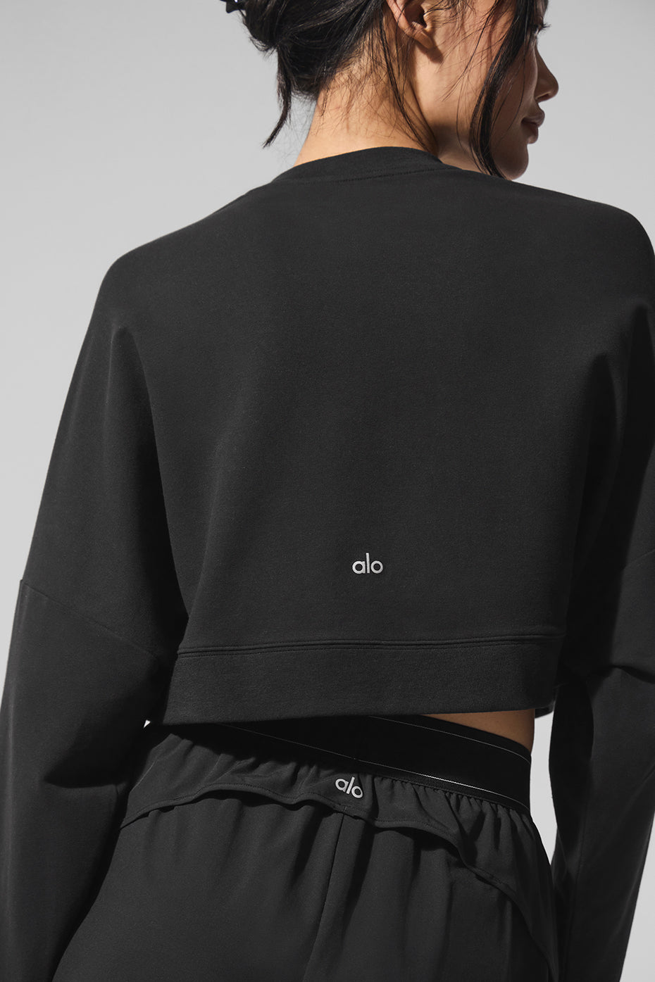 Side view showcasing the fit of the black pullover.