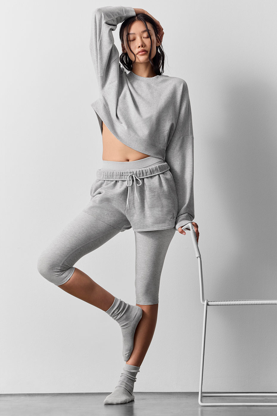 Model wearing cropped pullover with high-waisted leggings for athleisure look