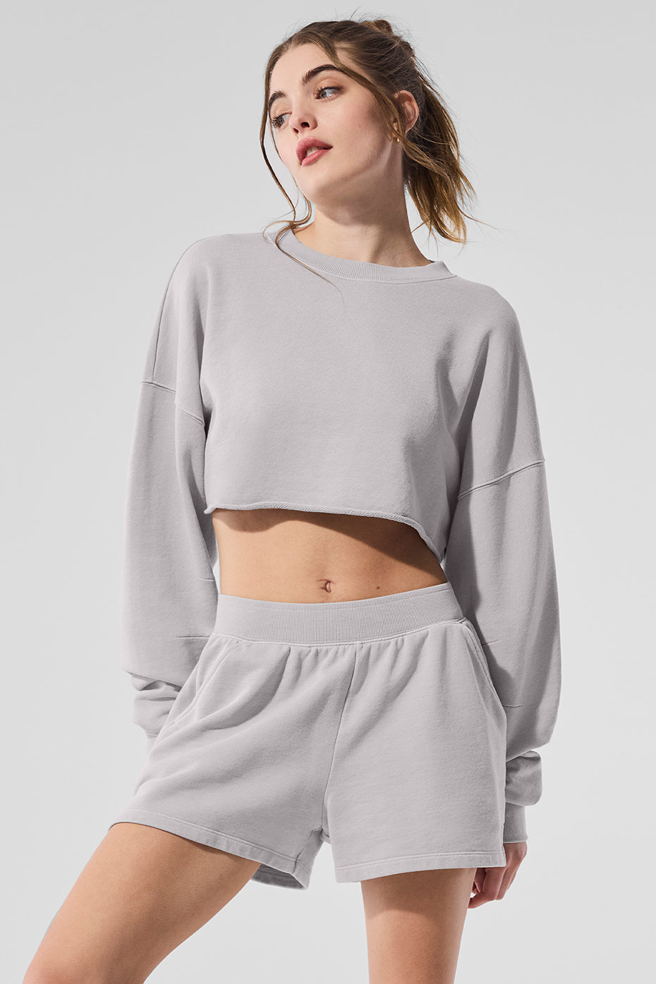 Front view of the grey sky cropped pullover, stylishly worn.
