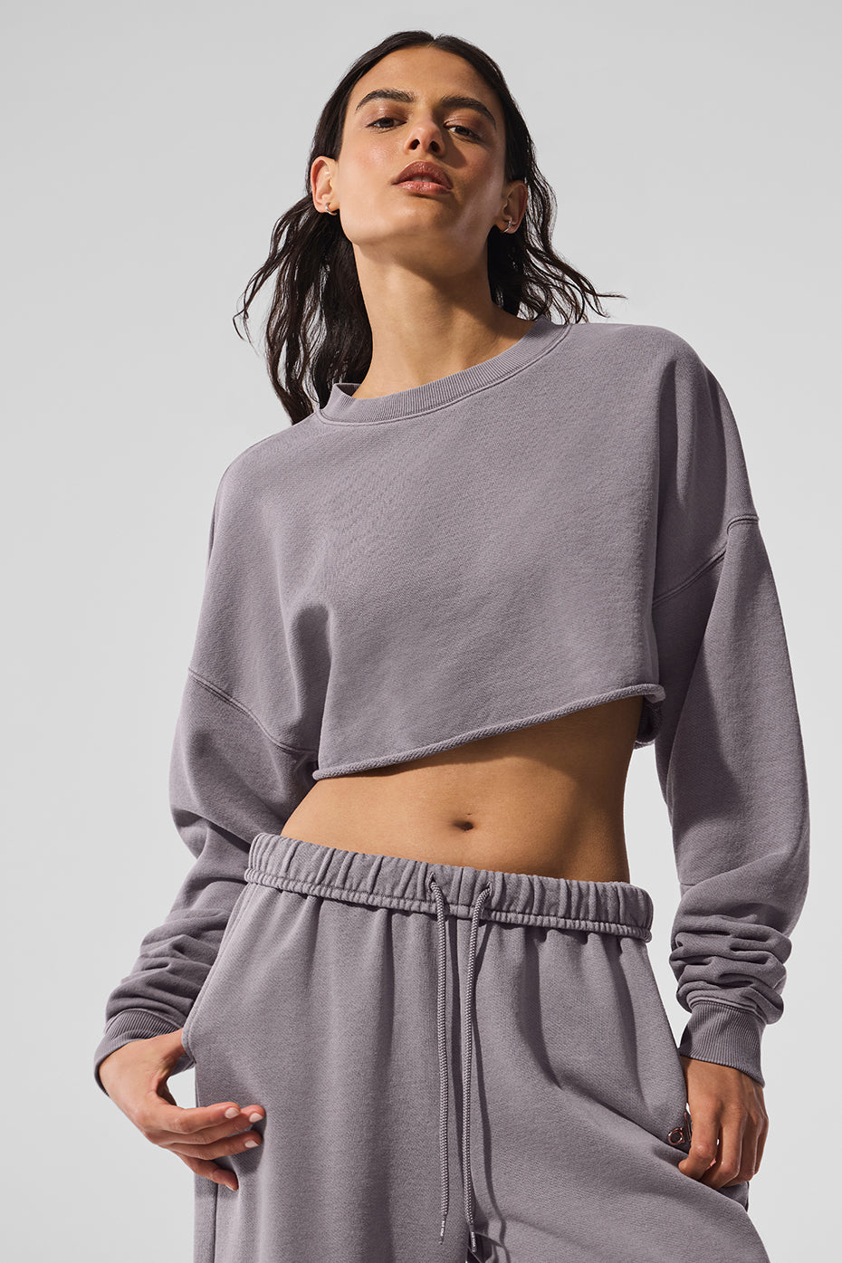 Model wearing the easy street crop pullover in a casual setting.