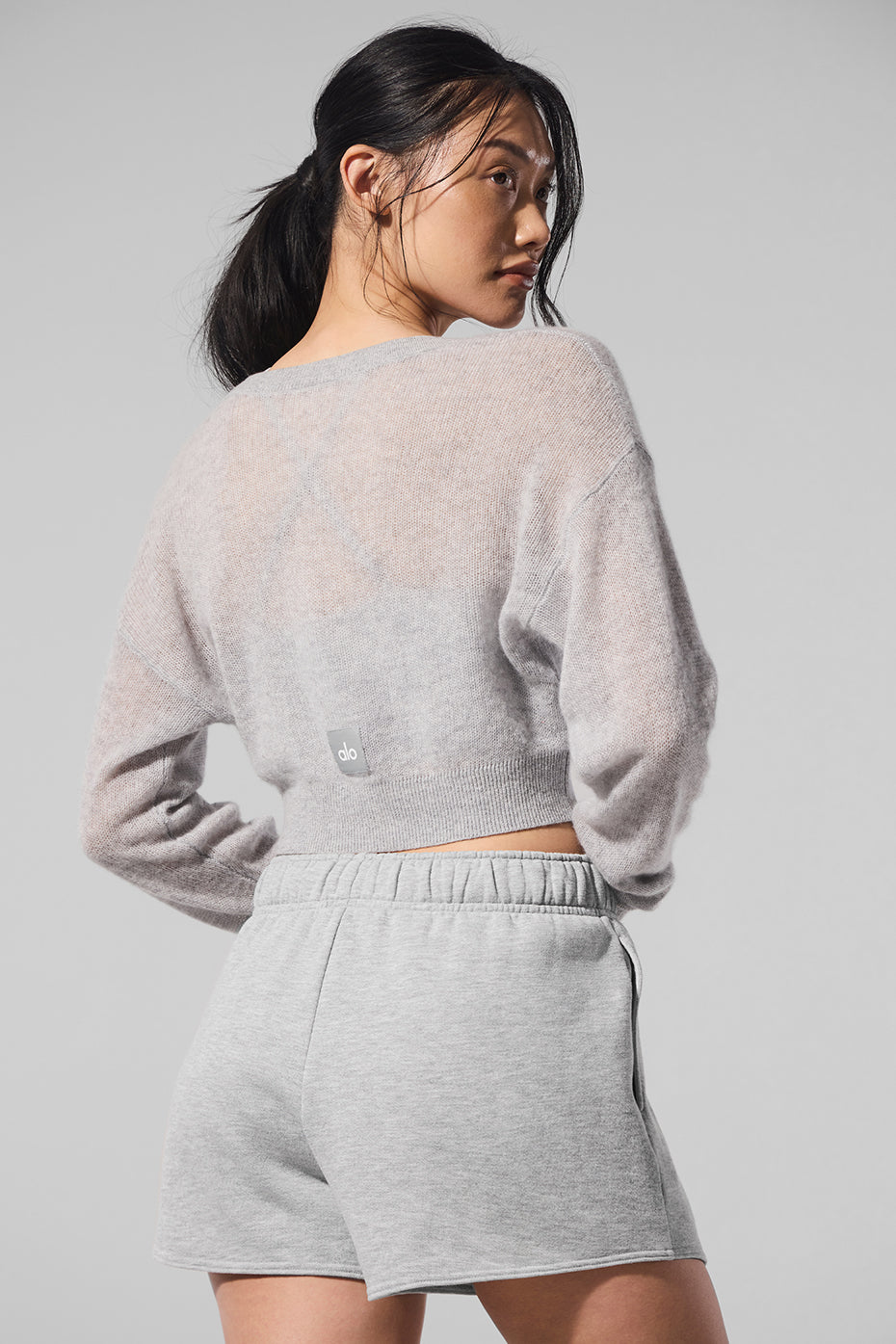 Back detail highlighting lightweight sheer finish and cropped hemline