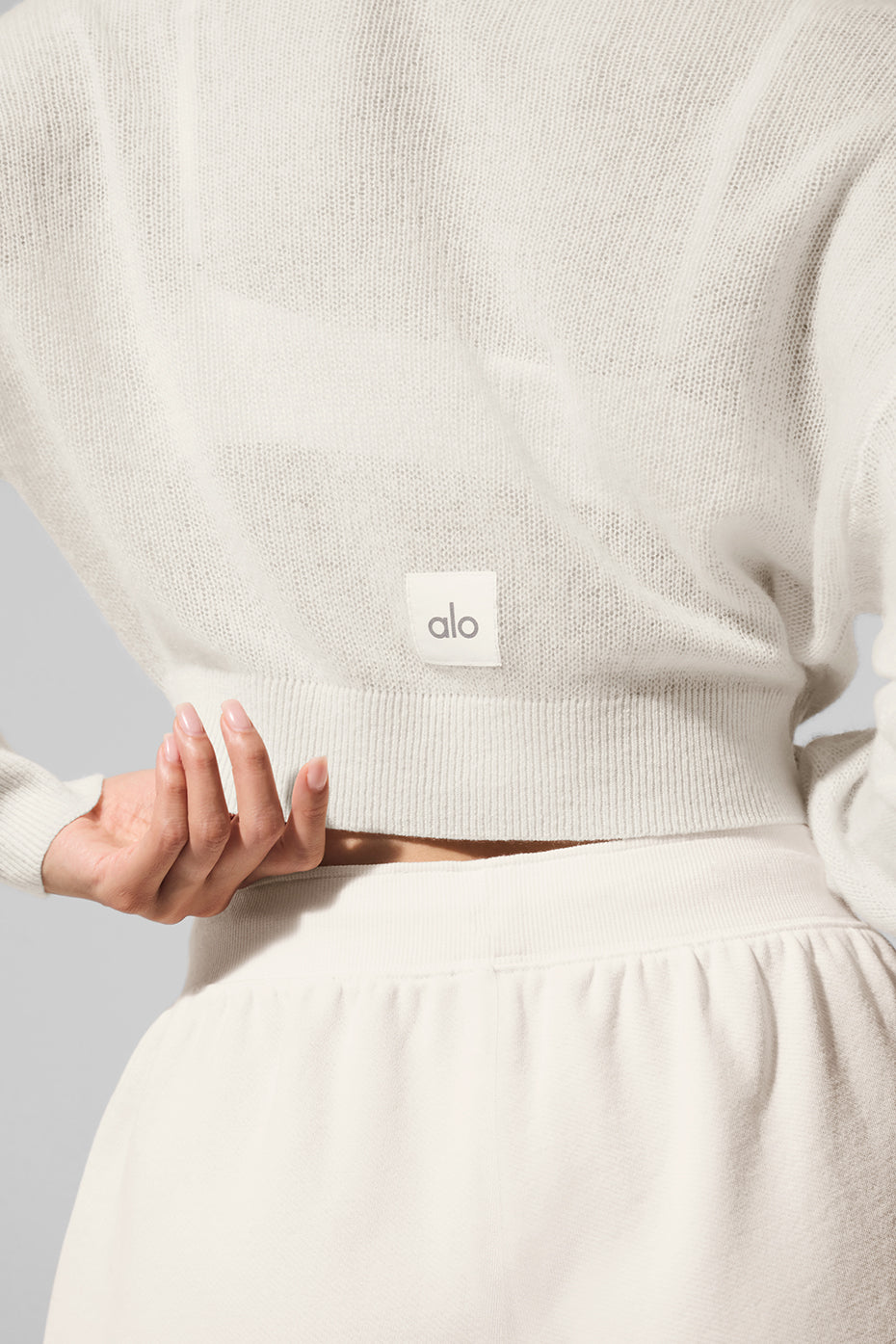 Close-up detail of the cardigans textured cashmere fabric