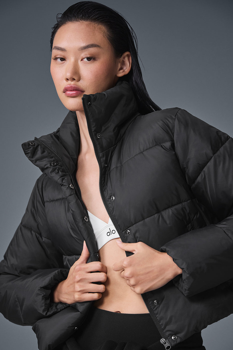 Close-up of the Gold Rush Puffer Jackets zippered pockets and tall collar