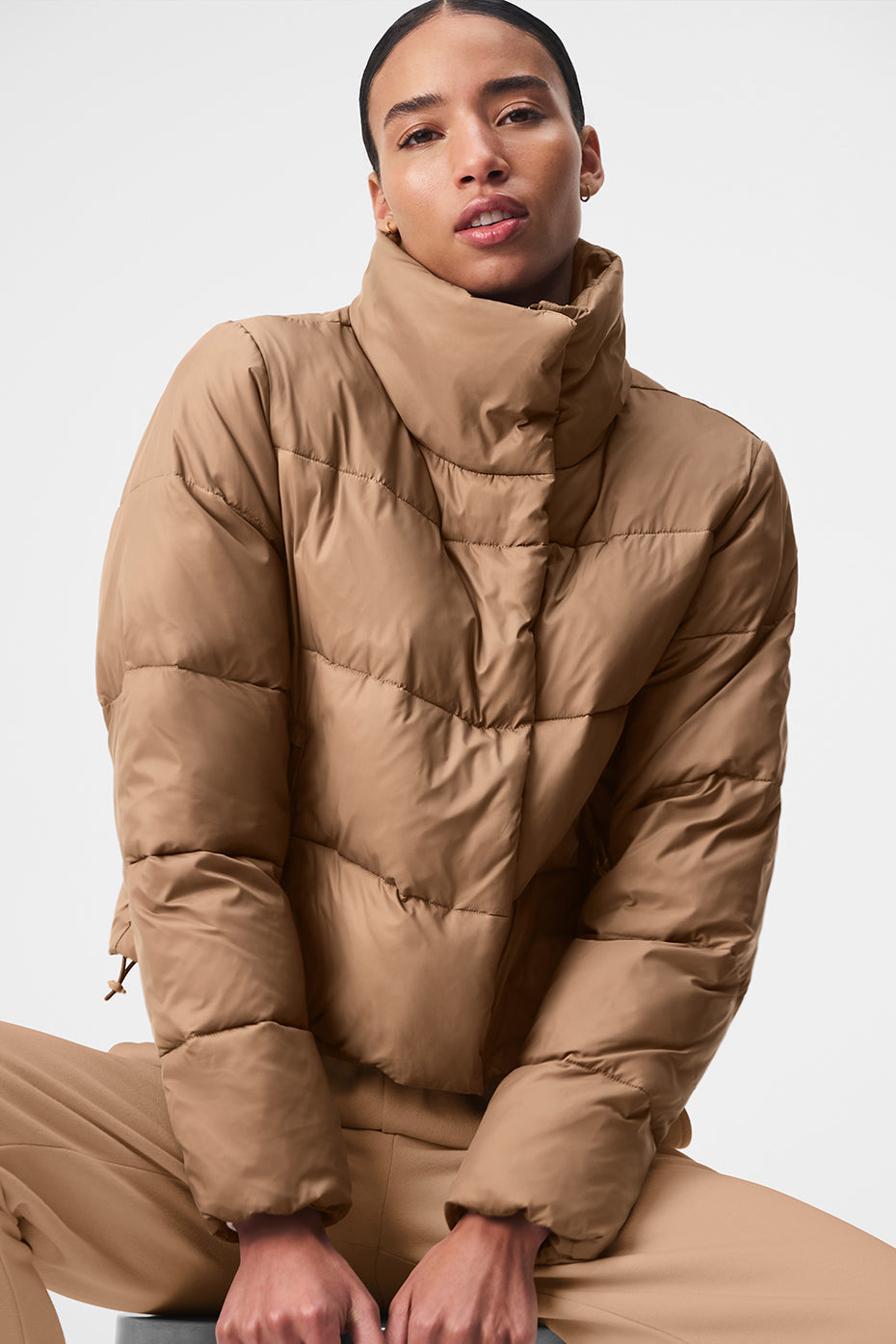 Front view of Toasted Almond puffer jacket showcasing its tall collar.