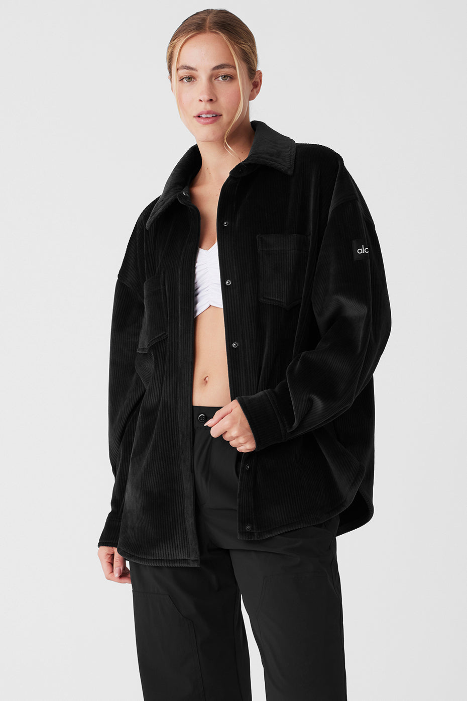 Front view of the black ribbed velour shacket on a model, showcasing its stylish design.
