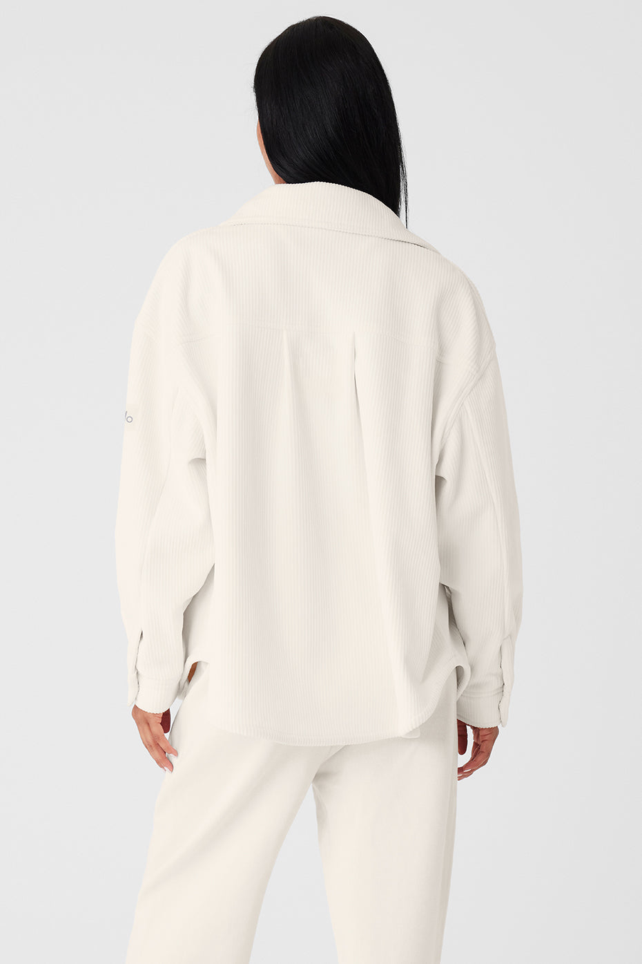 Side view showcasing the darted sleeve details of the shacket.