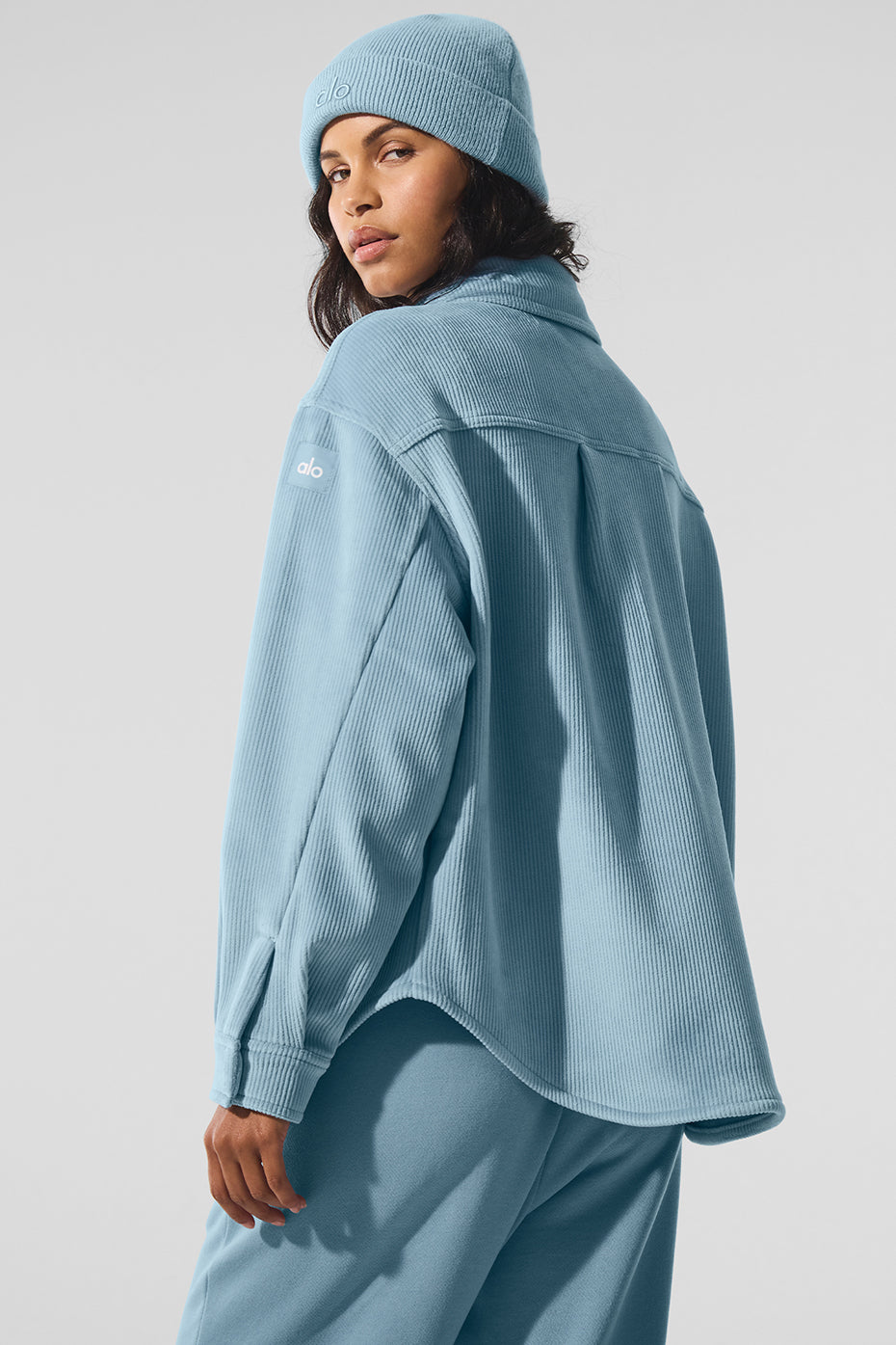 Close-up of velour jacket fabric with front snap closures and patch pockets