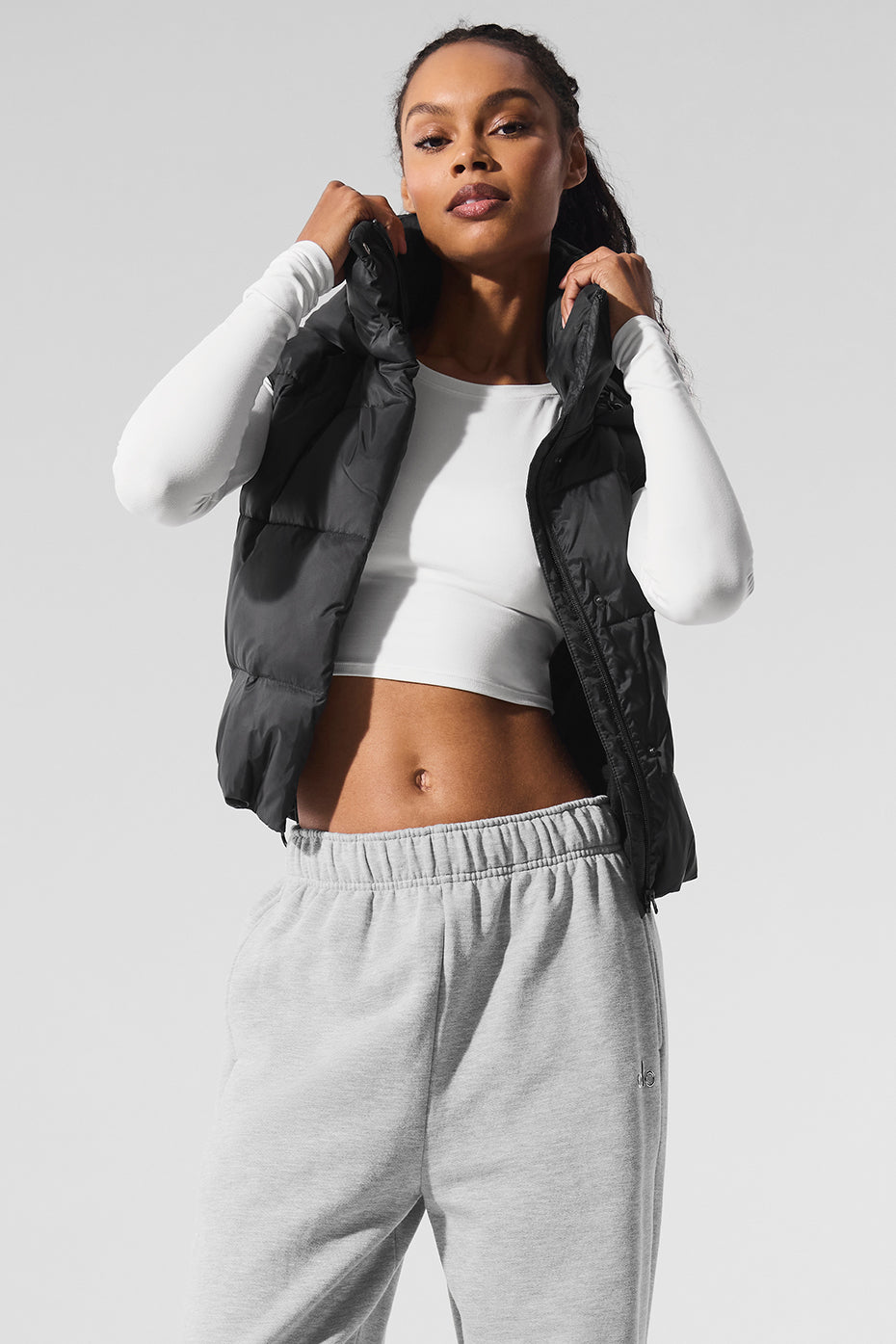 Close-up of the black puffer vest’s quilted texture and hooded collar