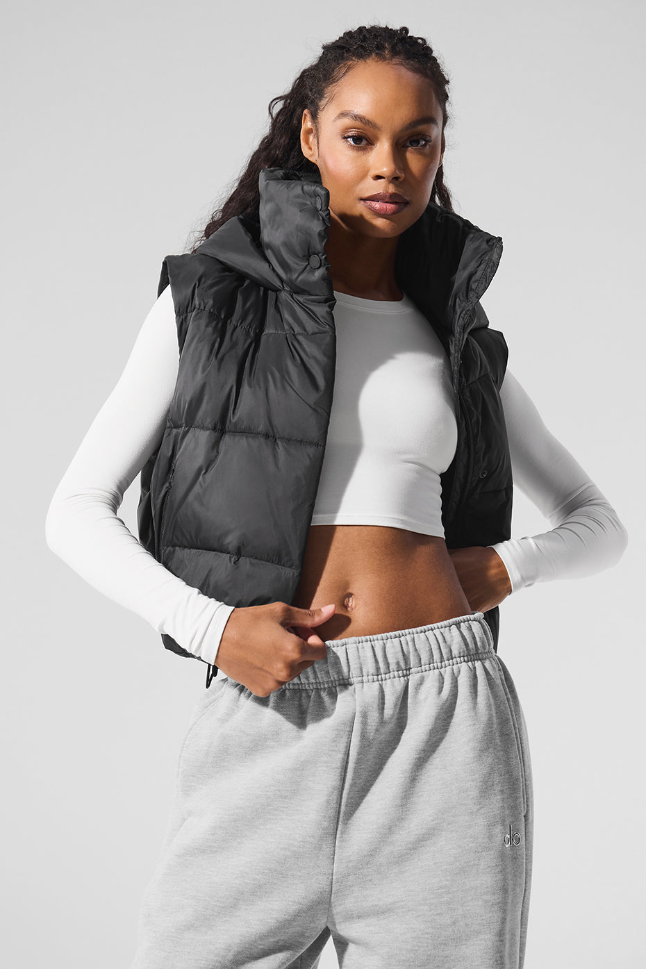 Close-up of the black puffer vest’s quilted texture and hooded collar