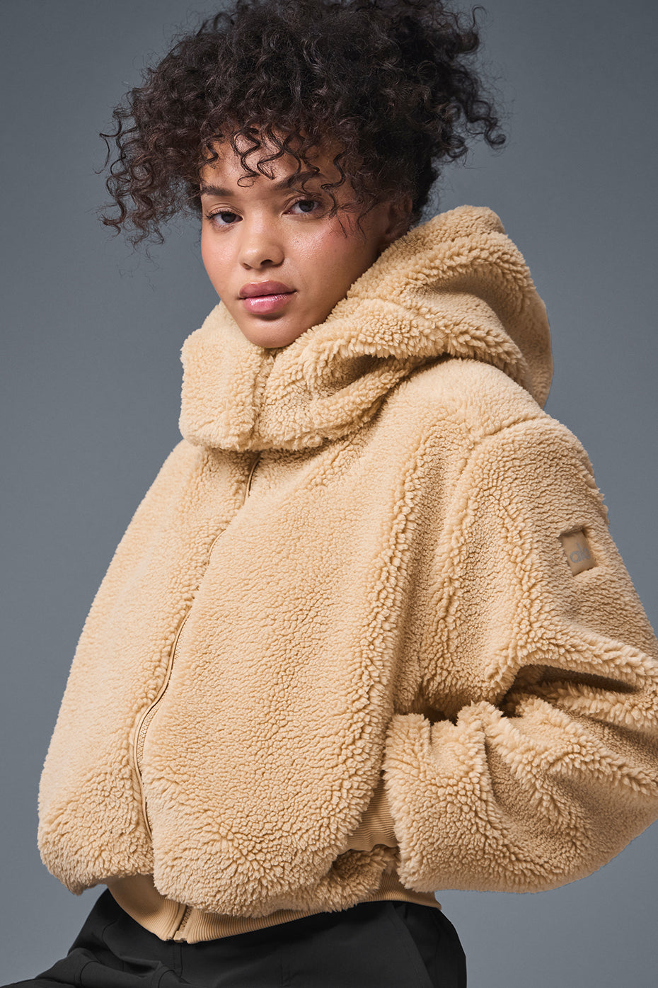 Front view of the Foxy sherpa jacket women in camel color, showcasing its relaxed fit and removable hood