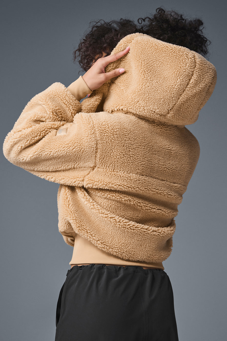 Detail of the plush sherpa fabric and ribbed cuffs on the womens sherpa jacket