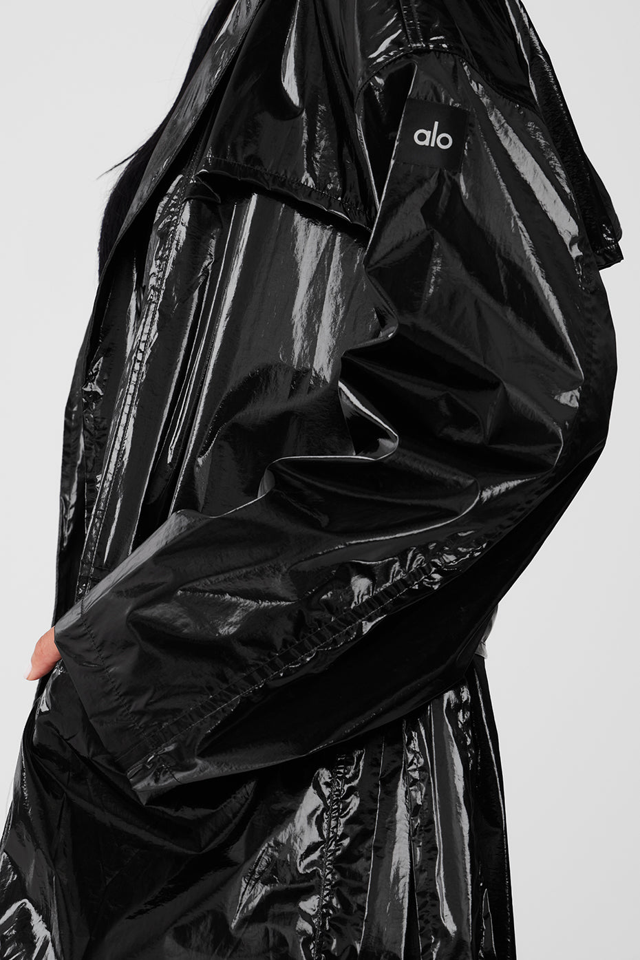Model wearing oversized hood street-ready trench coat with belt tied at waist