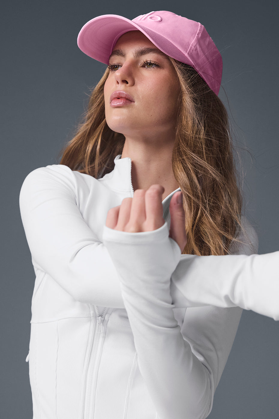 Detail shot of the zipper and thumbholes on the performance jacket for active use