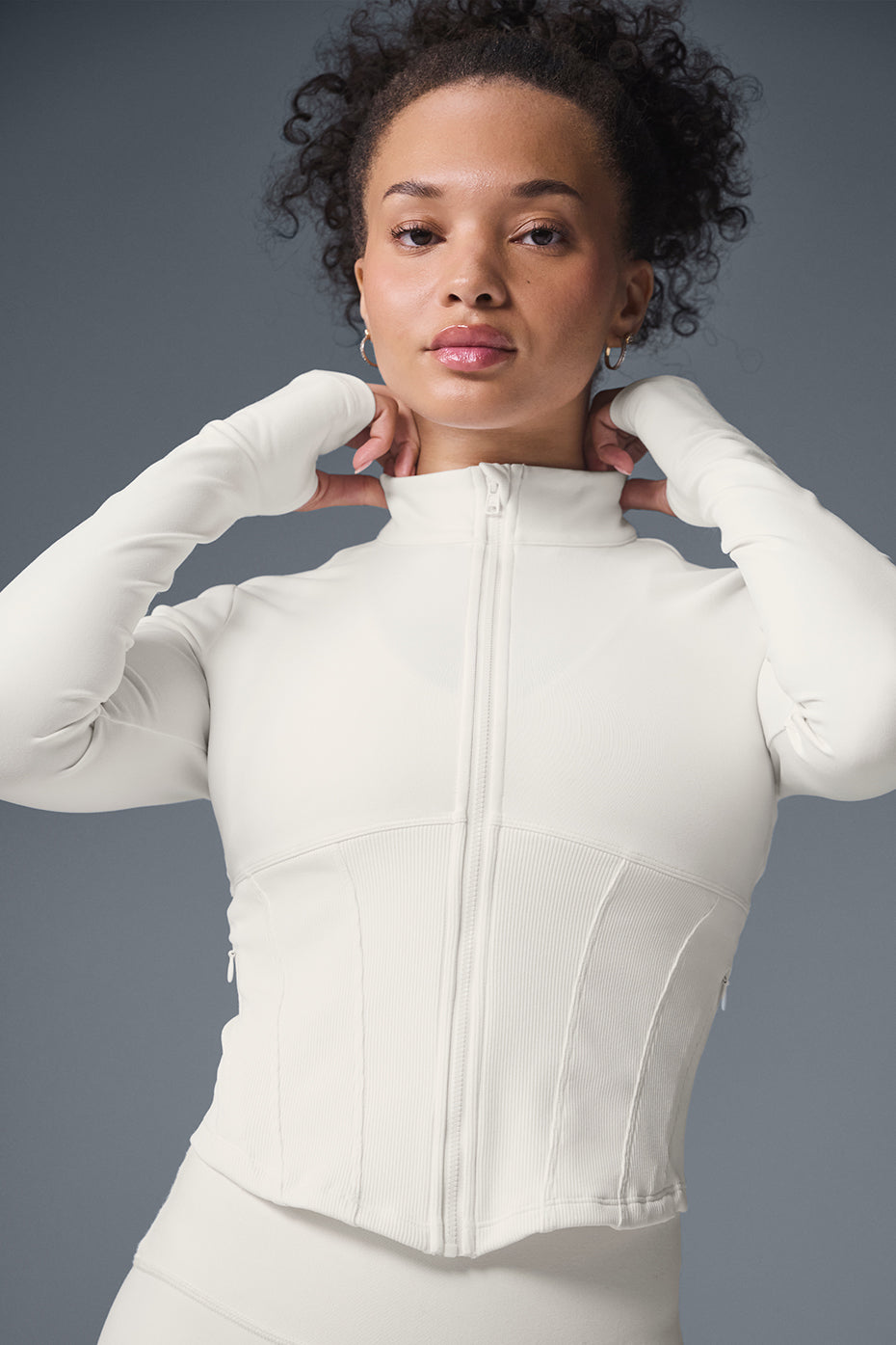 Front view of the ivory corset jacket with full zip and thumbholes.