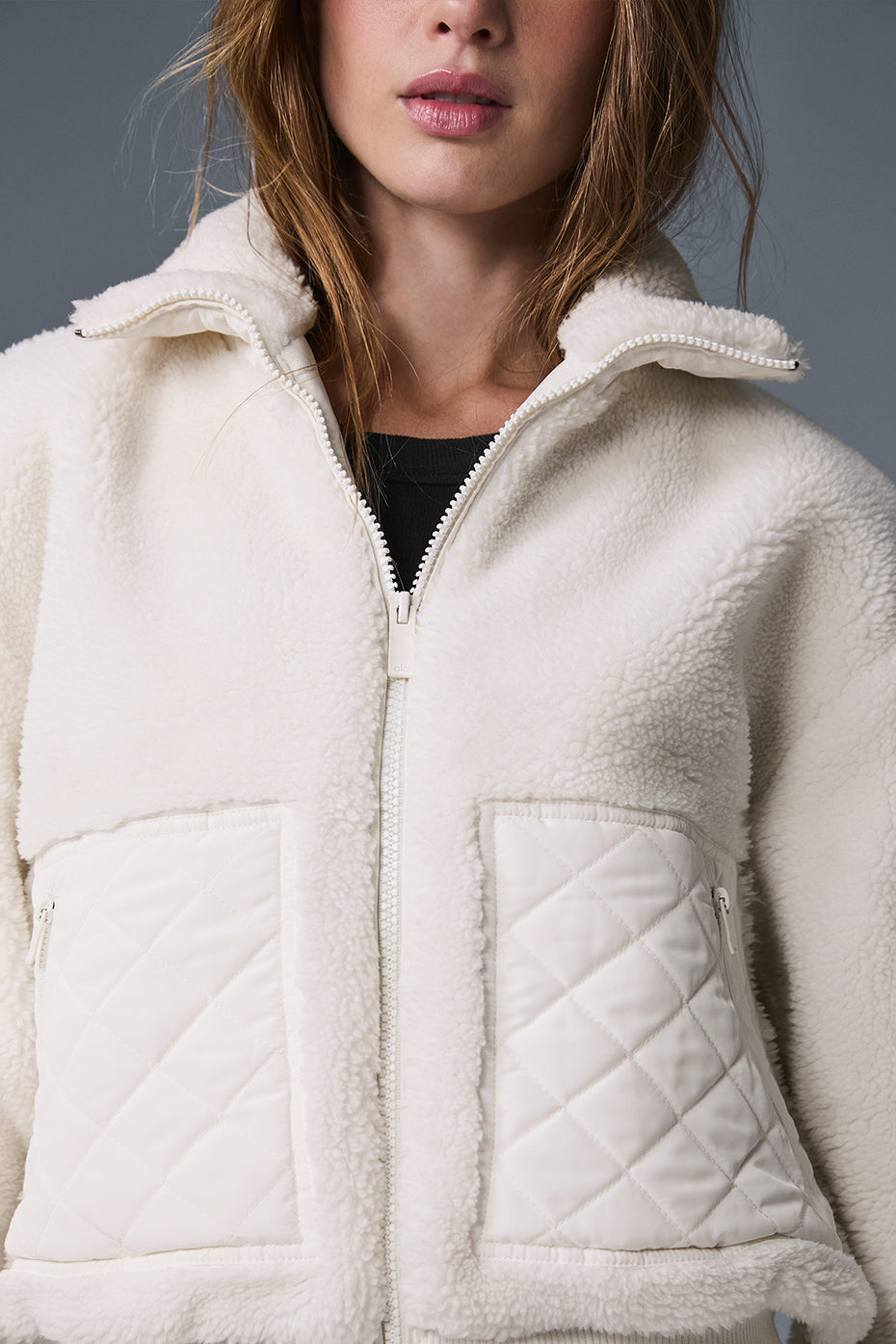 Back view of the ivory sherpa bomber jacket, featuring the sherpa-lined collar.