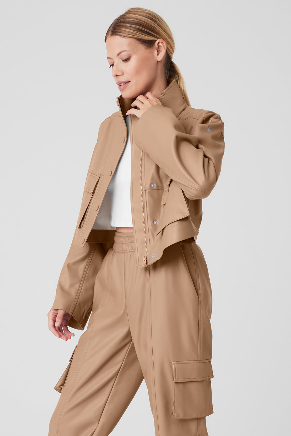 Close-up of the exaggerated flap pockets and tall collar of the jacket.