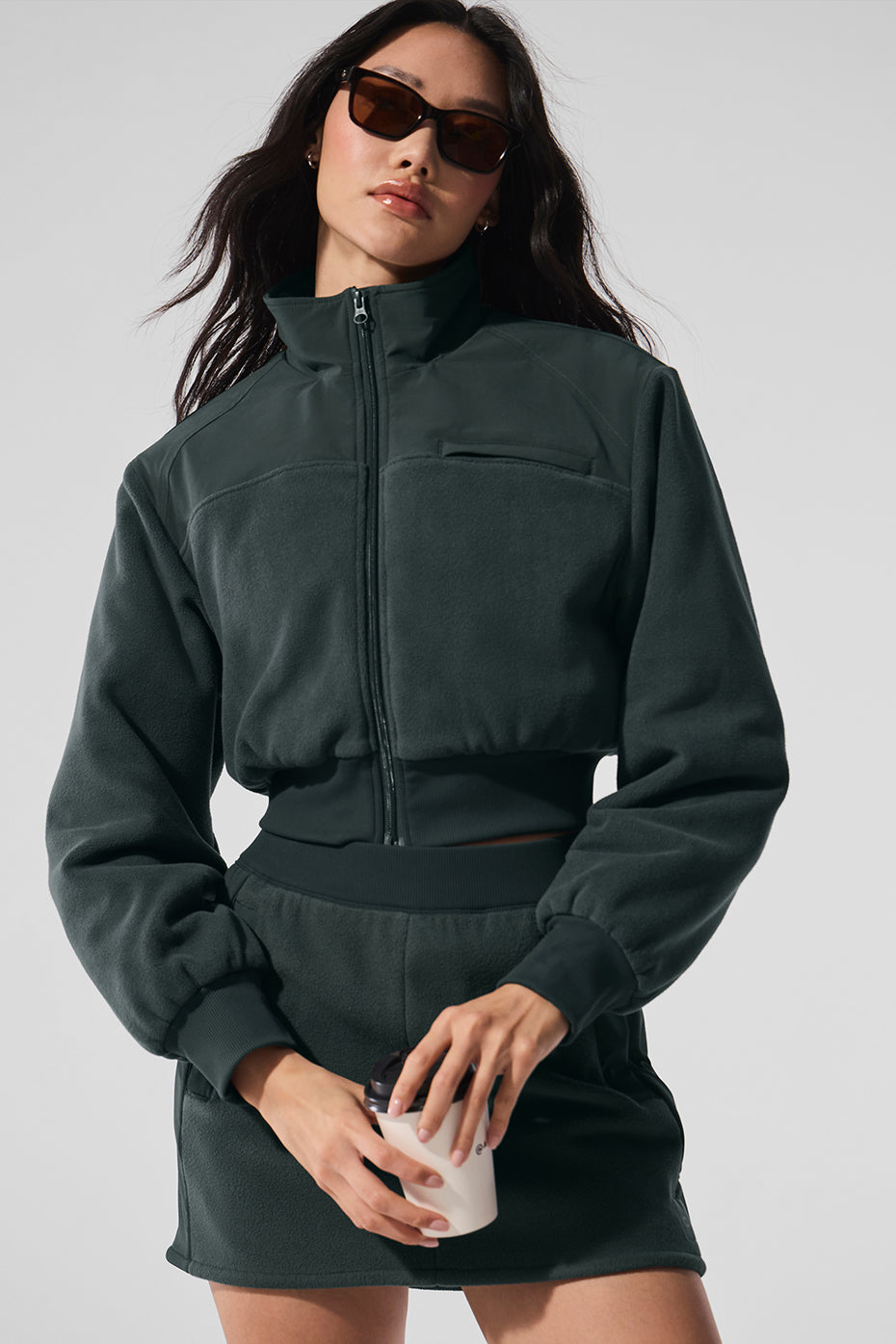 Front view of cropped winter jacket in charcoal green, showcasing its stylish design.