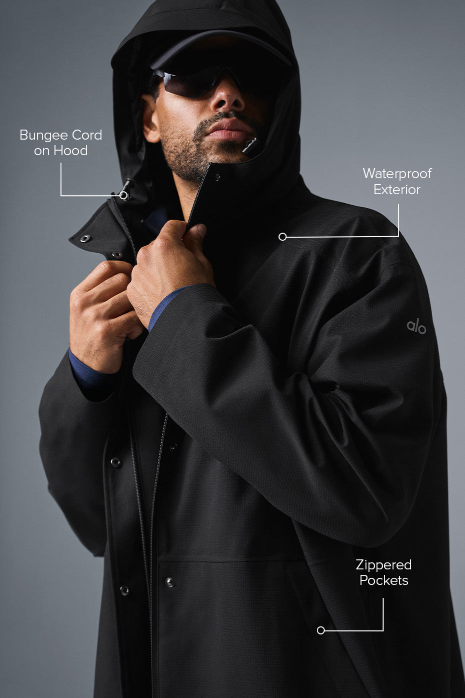 Side view of the long coat, highlighting the zippered pockets and relaxed fit.