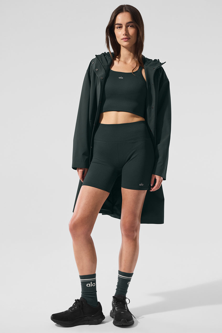 Model layering the charcoal green coat over a sweater