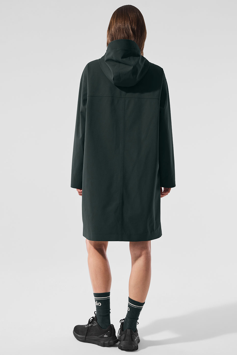 Close-up of zippered pockets and snap closure on long coat