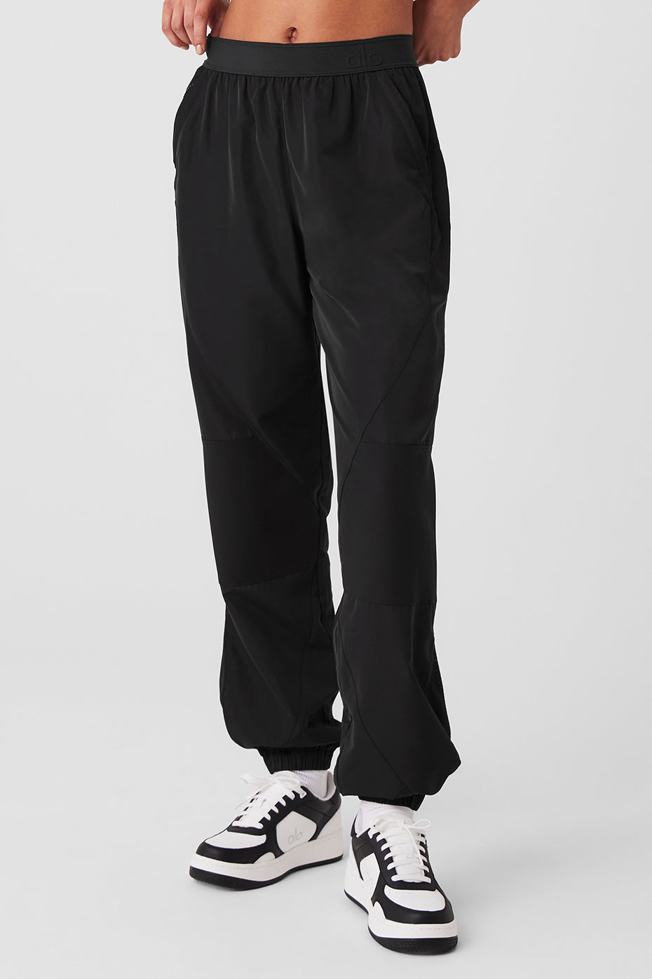 Side view of urban black joggers with contrasting panels.