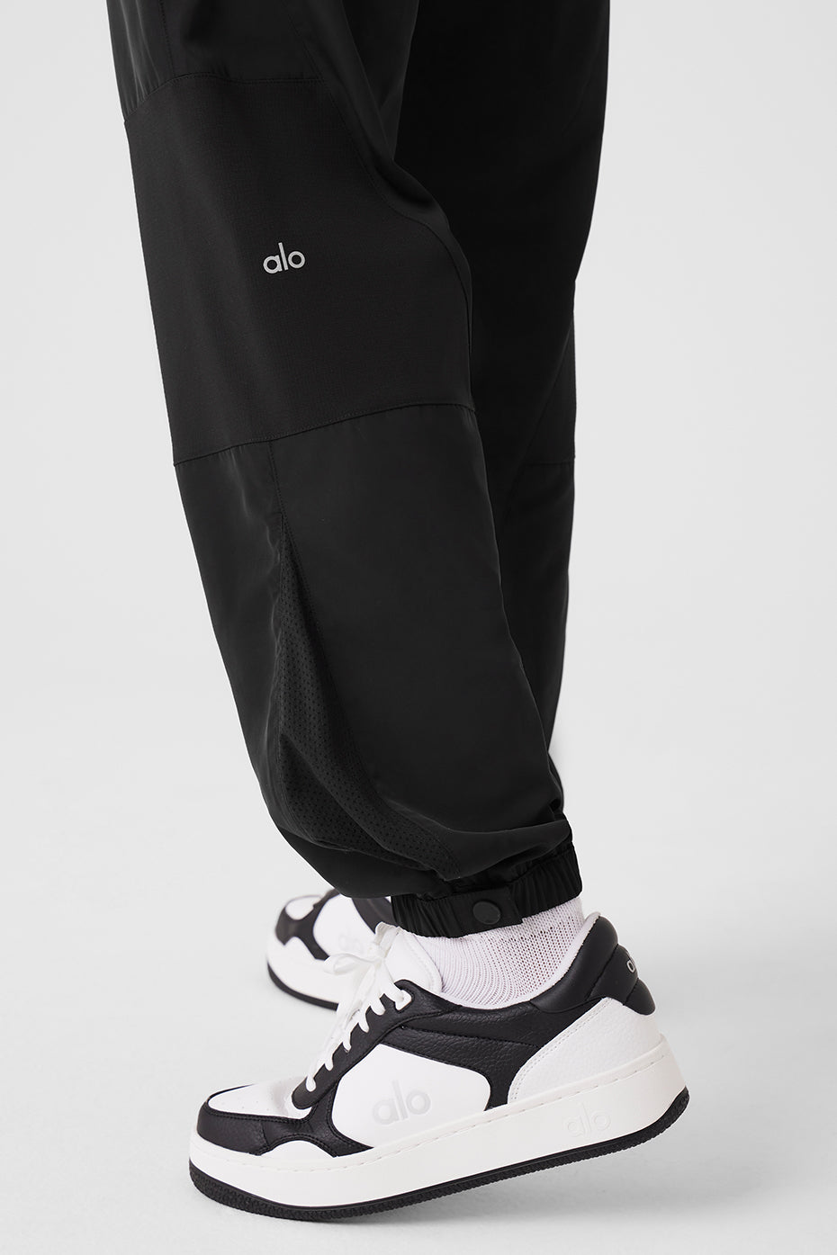 Side view of urban black joggers with contrasting panels.