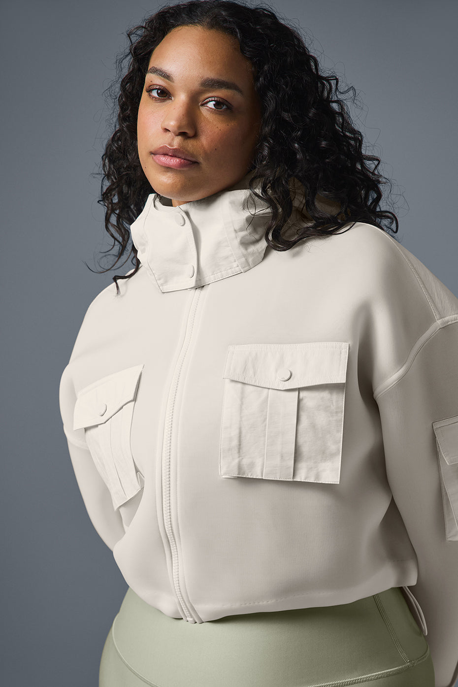 Side angle of the cropped cargo jacket highlighting the trendy snap pockets.