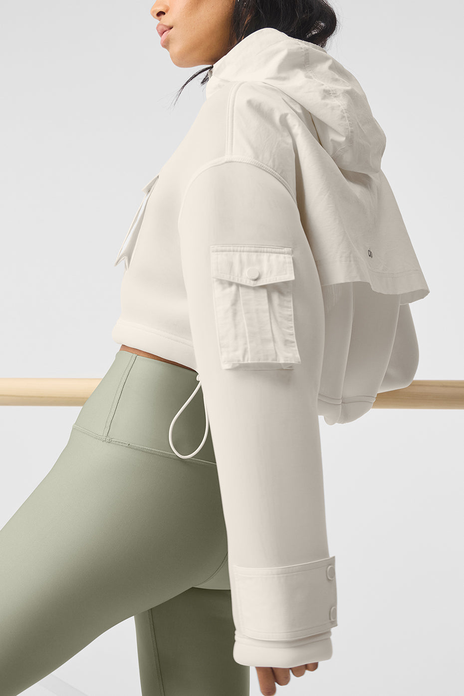 Side angle of the cropped cargo jacket highlighting the trendy snap pockets.