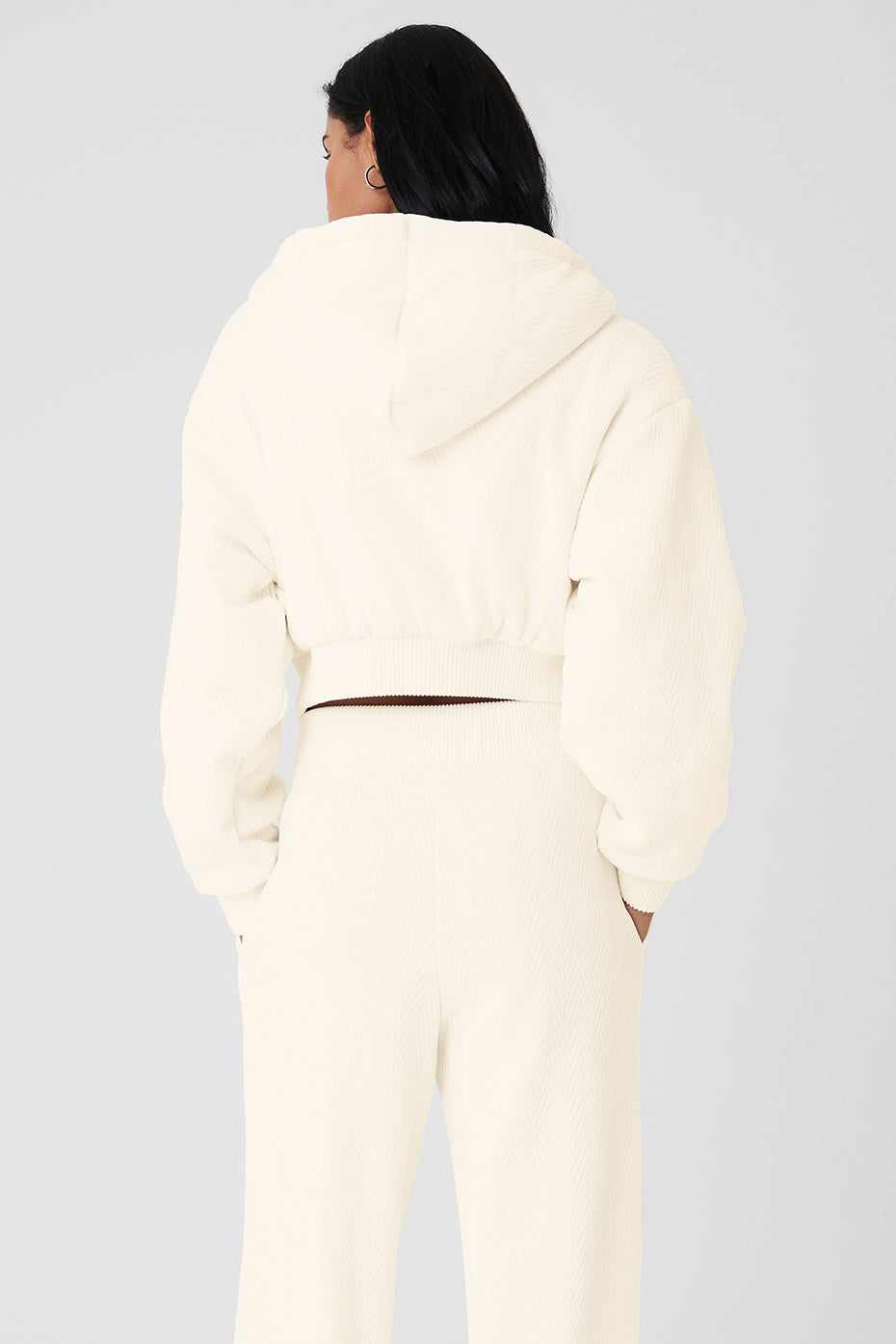 Close-up of ribbed cuffs and full zipper on cropped bomber jacket