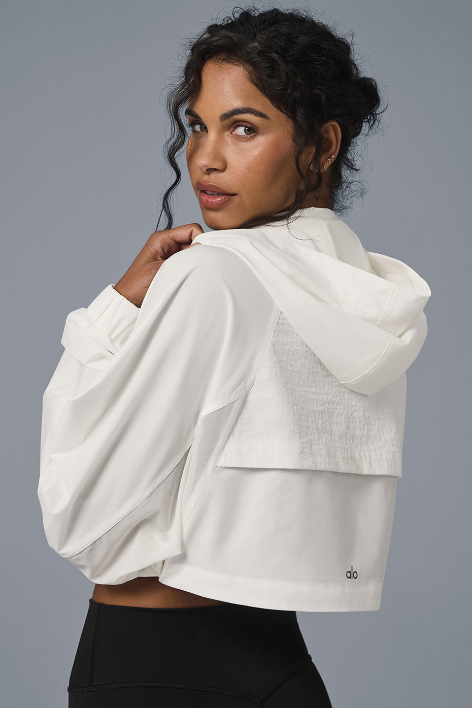 Back view of the Cropped Playmaker Jacket, featuring the hood and elastic cuffs.