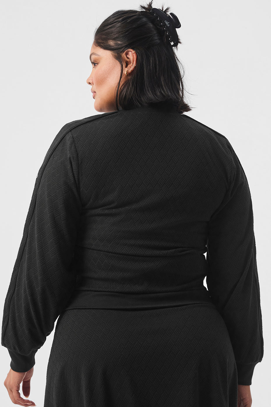 Model wearing cropped leather jacket with ribbed collar from side view