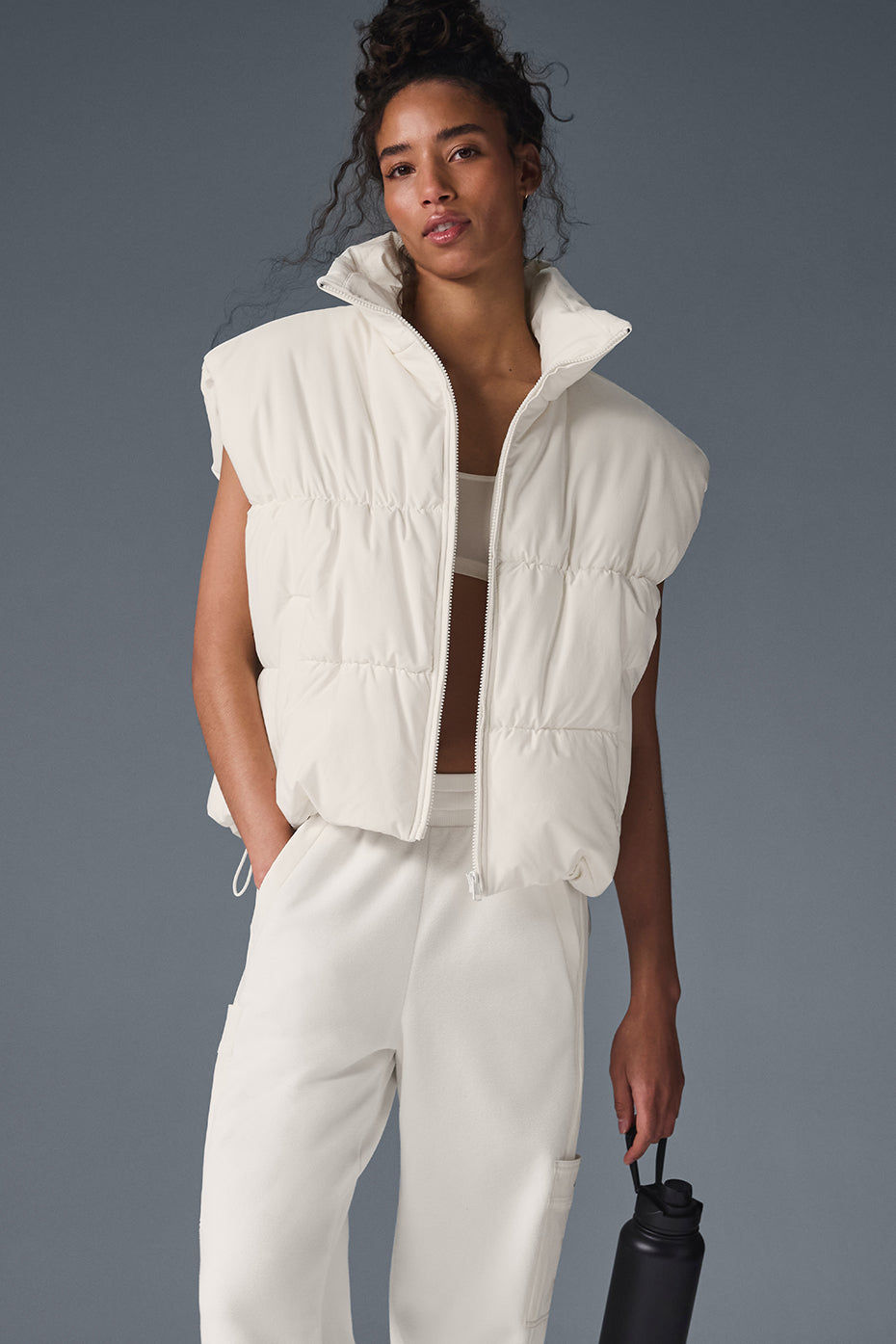 Front view of chic ivory puffer vest for men and women.