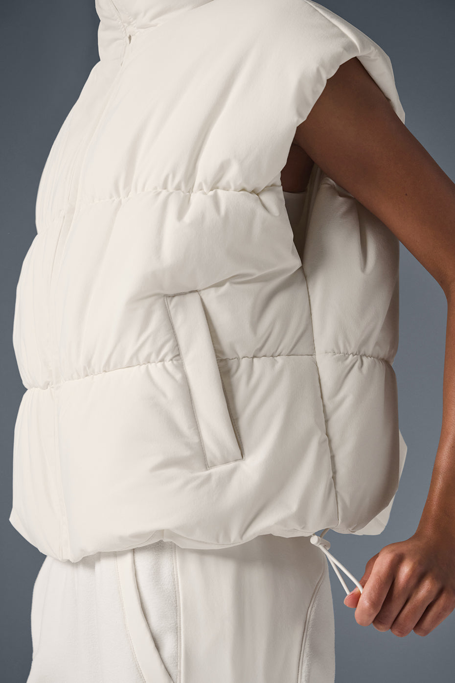 Side view showcasing the oversized fit of the puffer vest.