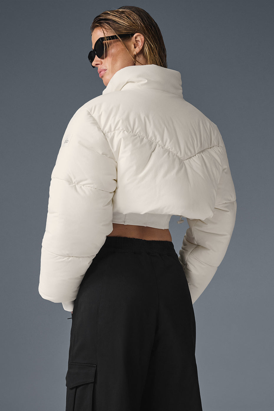 Back view showing cropped silhouette of puffer jacket