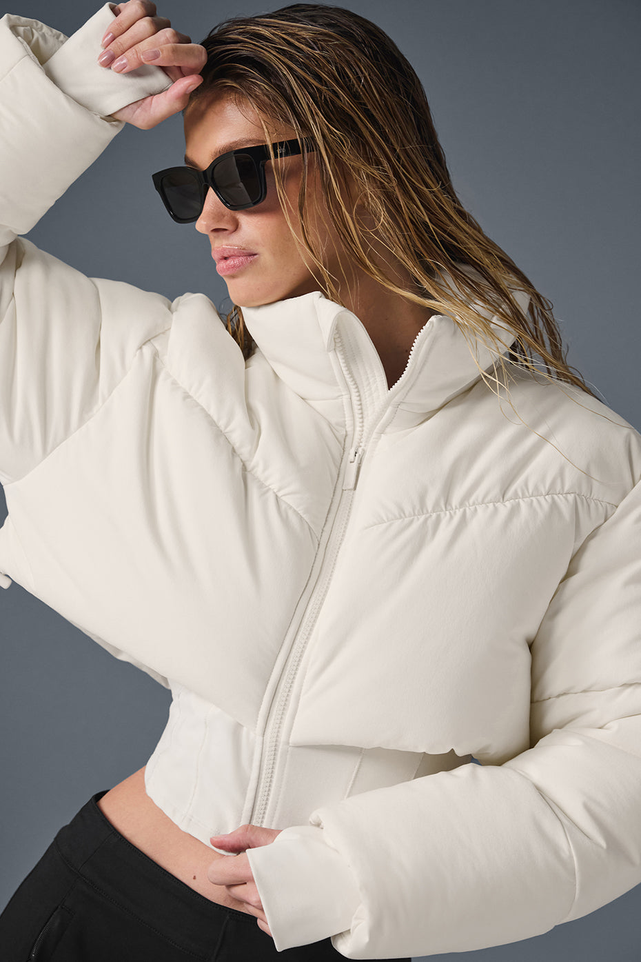 Front view of model wearing the waist-snatching puffer