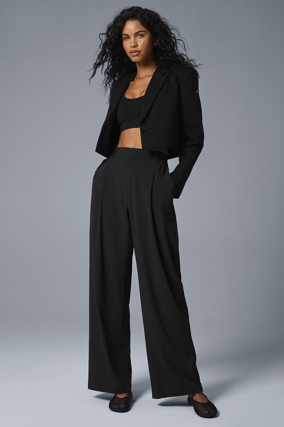 Back view of oversize blazer layered over a slip dress for evening wear