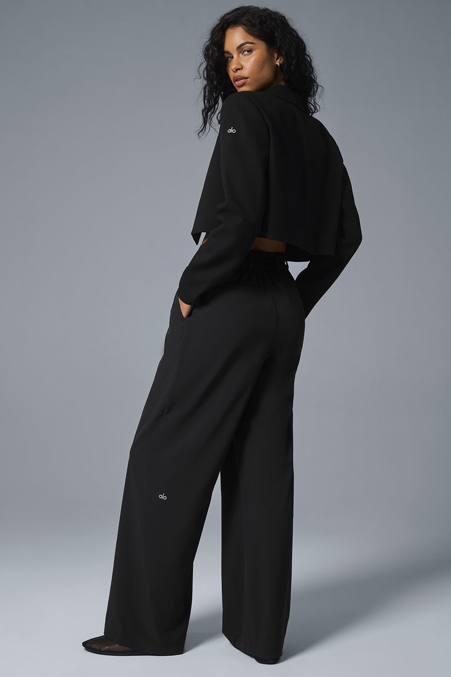 Close-up of cropped blazer details: notched lapels and single-button closure