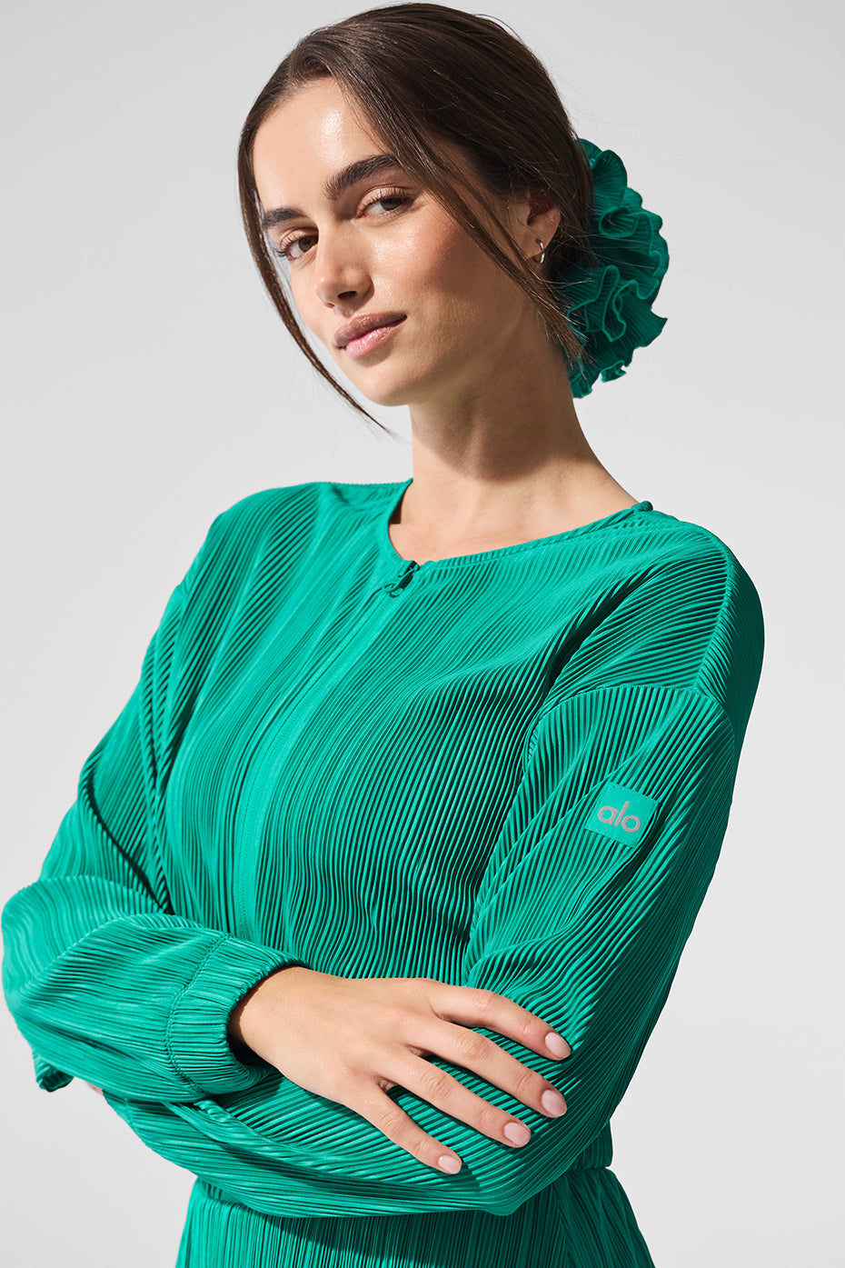 Model wearing cropped micro plisse jacket on city street during daytime