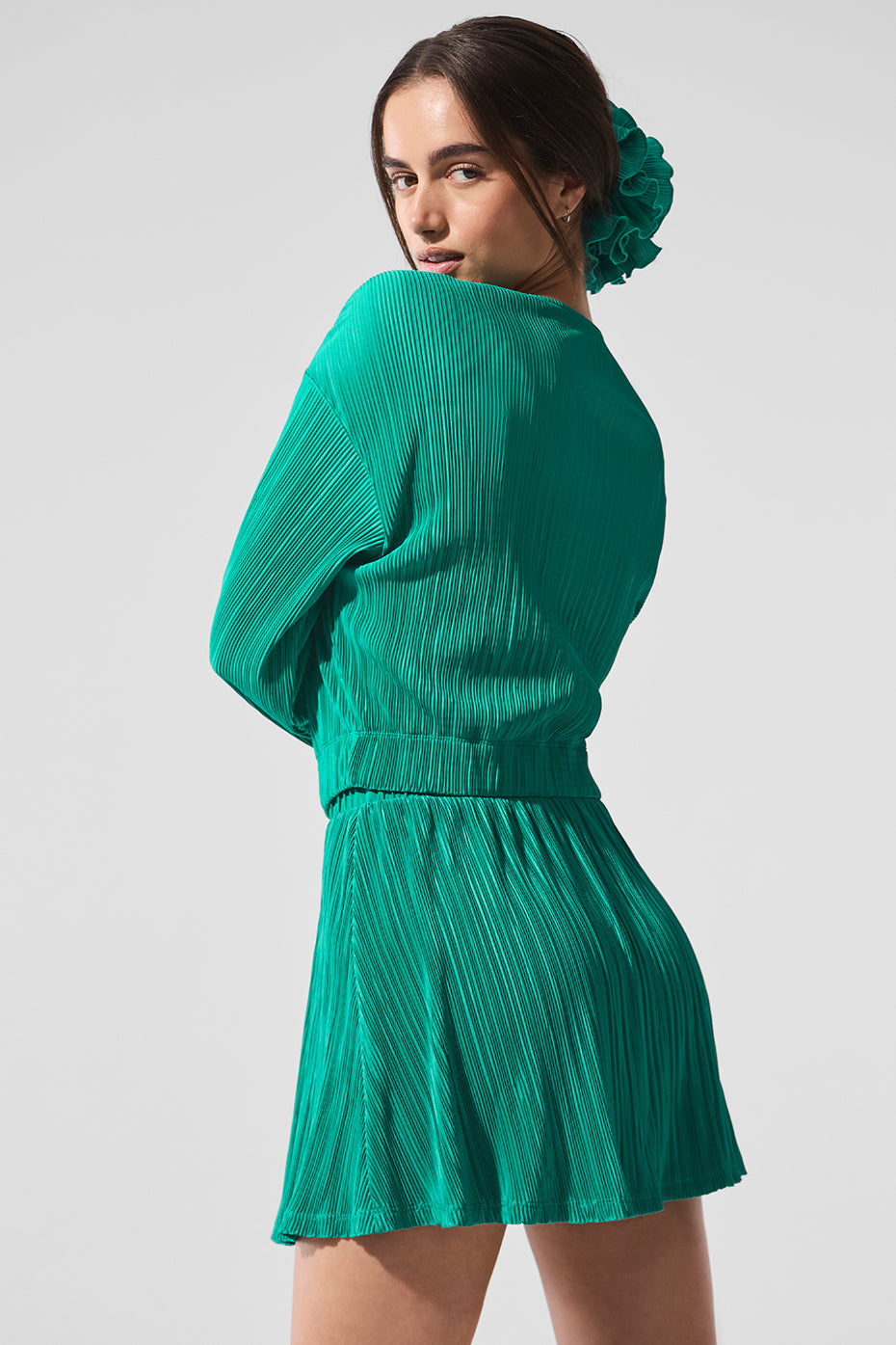 Detail shot of crinkly mini-pleat texture and elastic cuffs on spruce green jacket