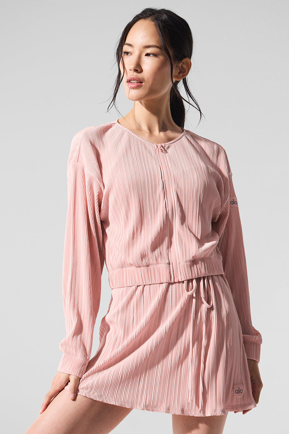 Front view of the pink quartz micro plisse jacket showcasing its cropped silhouette and billowy sleeves