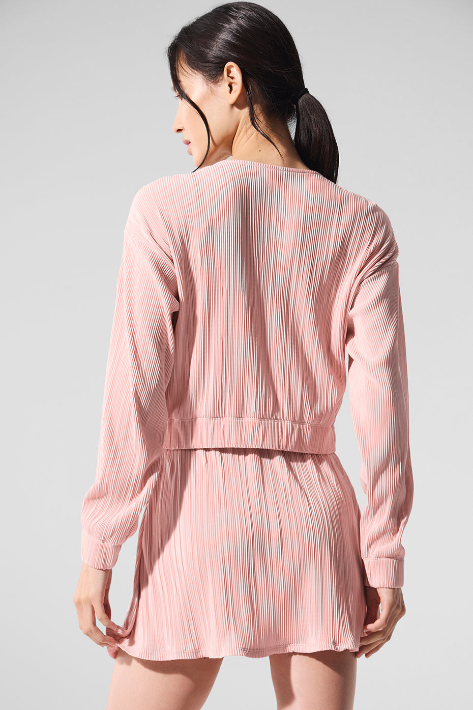 Front view of the pink quartz micro plisse jacket showcasing its cropped silhouette and billowy sleeves