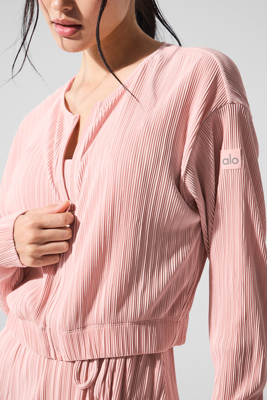 Detail shot of the crinkly mini-pleat texture on the pink quartz jacket fabric