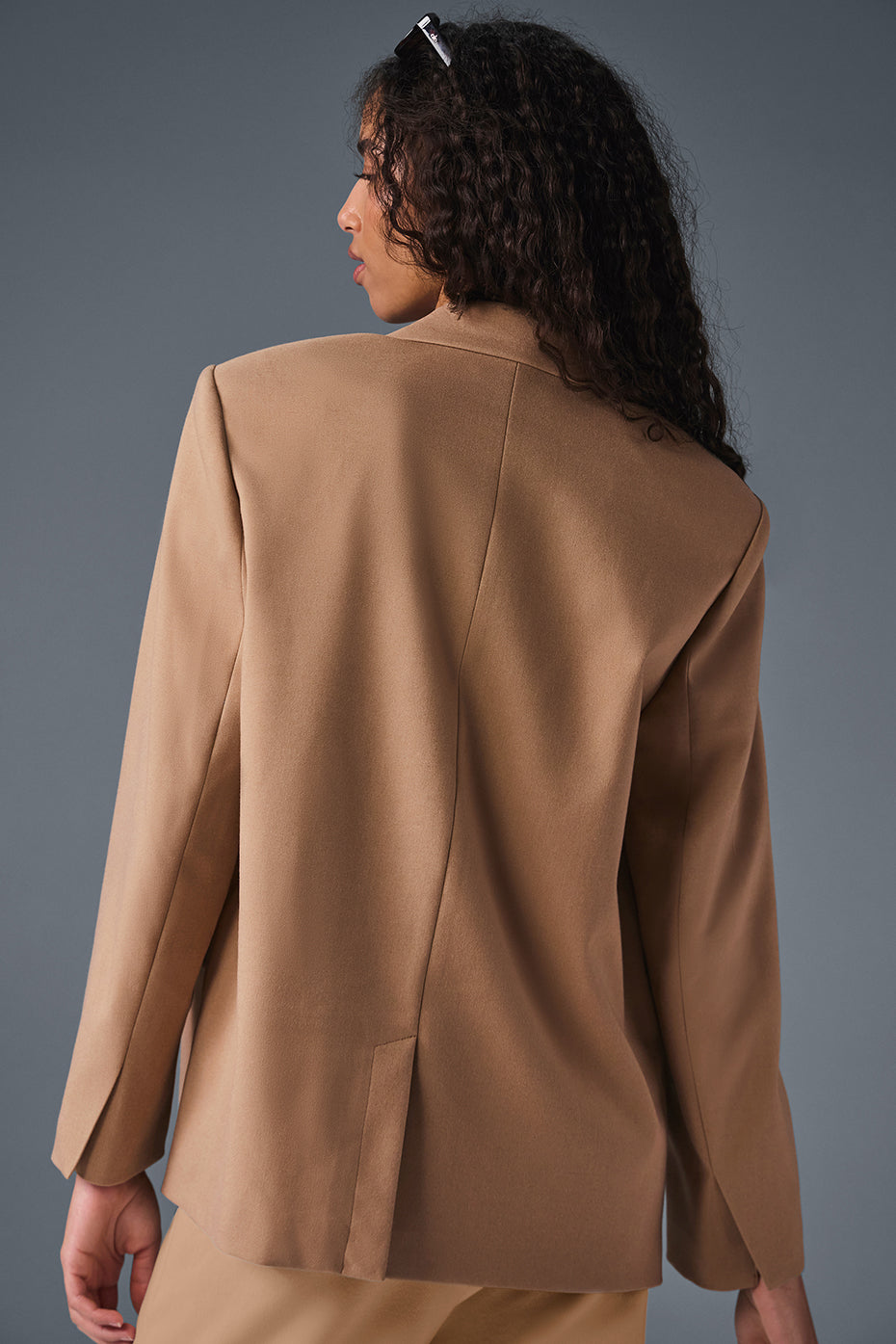 Model wearing a blazer dress version of the oversized blazer for a chic evening look