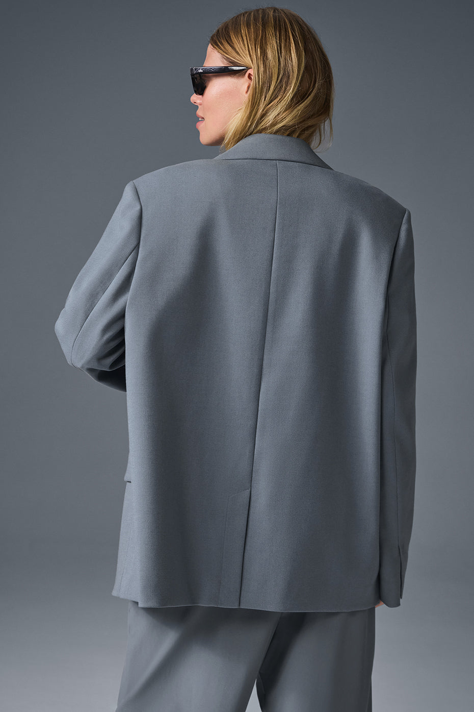 Side view of the womens tweed blazer, highlighting the shoulder pads.