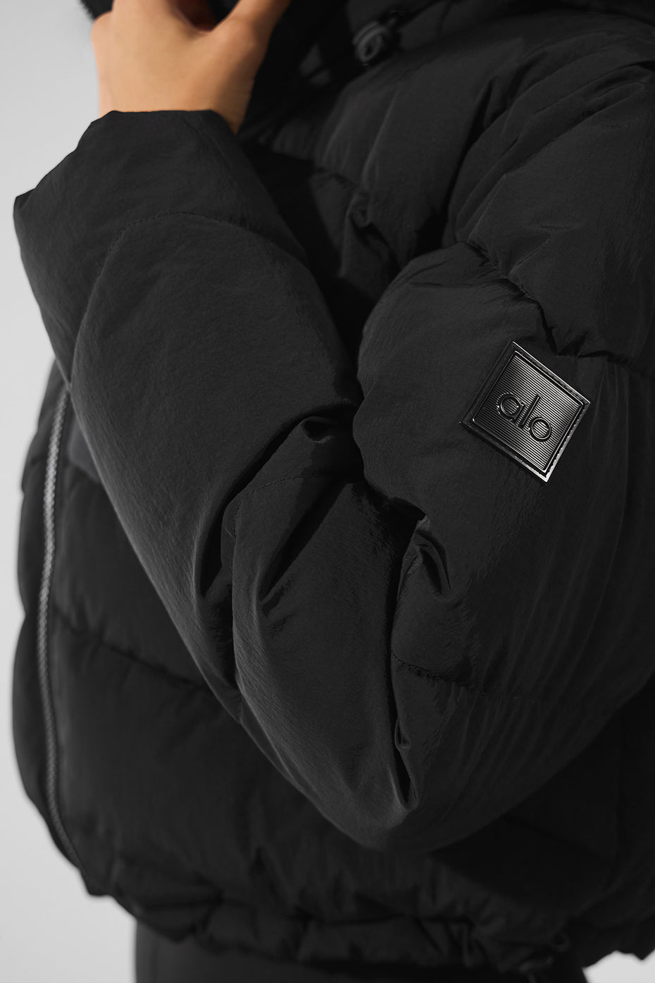 Side view of the Glacier Black Puffer Jacket highlighting the double-zip closure.