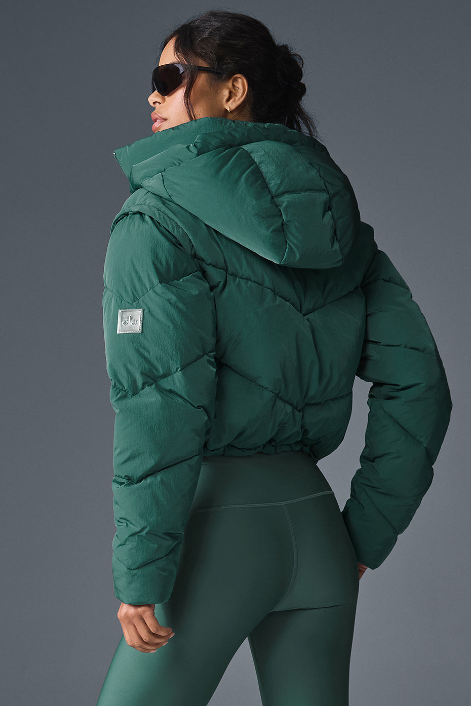 Side view showcasing the double-zip closure of the black puffer jacket.