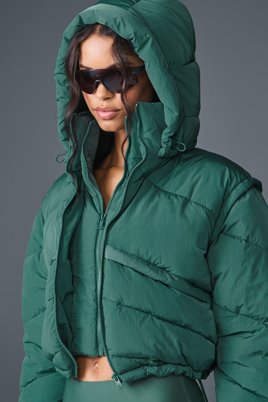Side view showcasing the double-zip closure of the black puffer jacket.